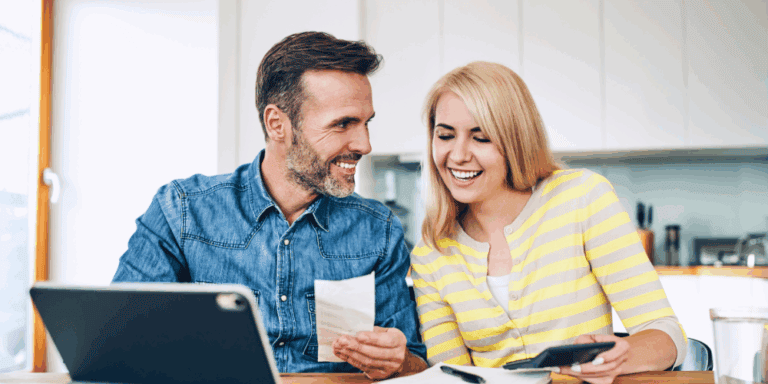 An Edmonton couple smile excitedly as they finance their home comfort upgrades with Vault.