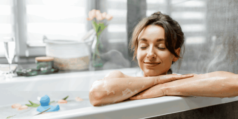 A woman relaxes in a steamy bath! No running out of hot water with deals on a new hot water tank or tankless hot water system.