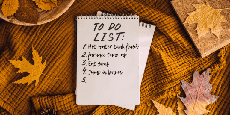 A to do list sits in a pile of autumn leaves. Hot water tank maintenance, furnace tune ups, soup making and leaf jumping!