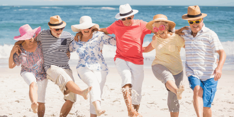 Six seniors happily dance in a line on the beach. Excited about vacation and being away from the cold Edmonton winter. Especially knowing they got great discounts on all the home heating prep they needed.